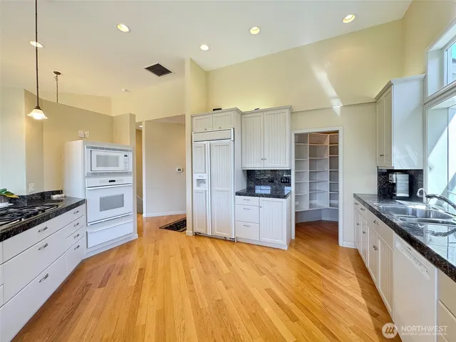 a large kitchen with a lot of counter space and stainless steel appliances