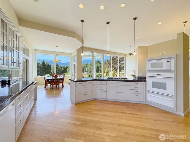 a kitchen with stainless steel appliances granite countertop a stove and refrigerator