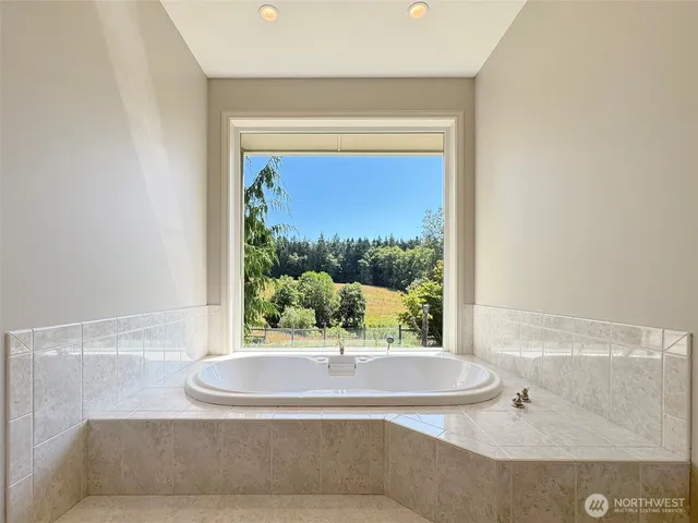 a bathroom with a bathtub and window