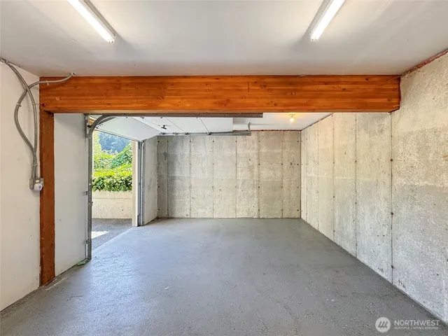 a view of empty room with wooden floor and entryway