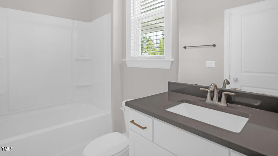 176 Red Jasper Way Clayton, NC 27520 - Photo 13 of 35 a bathroom with a sink and a bathtub