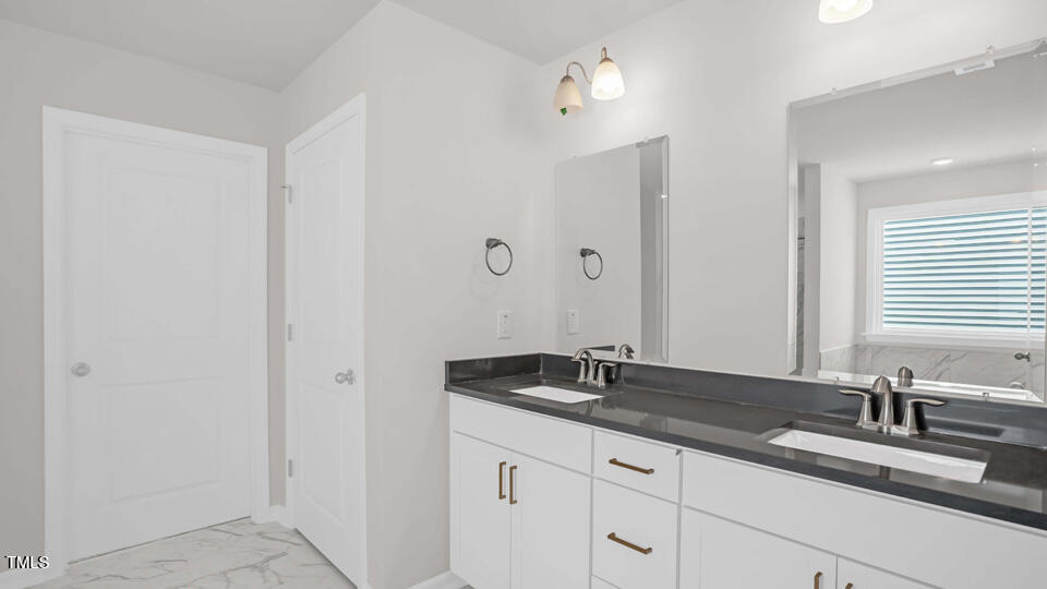 176 Red Jasper Way Clayton, NC 27520 - Photo 17 of 35 a bathroom with a sink and a mirror
