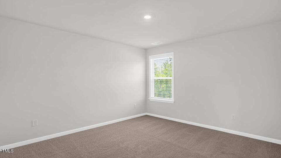 176 Red Jasper Way Clayton, NC 27520 - Photo 22 of 35 an empty room with a window