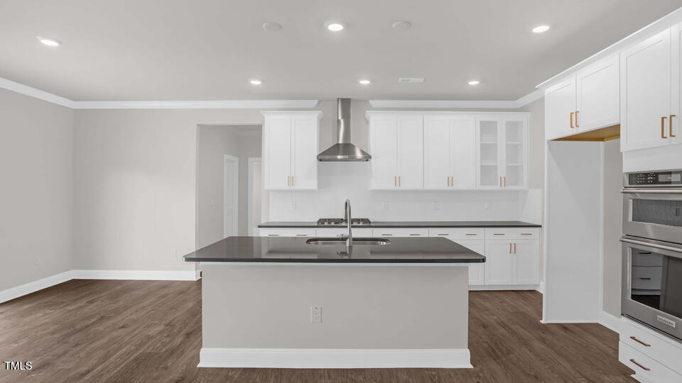 176 Red Jasper Way Clayton, NC 27520 - Photo 8 of 35 a kitchen with stainless steel appliances granite countertop a sink a stove and a refrigerator