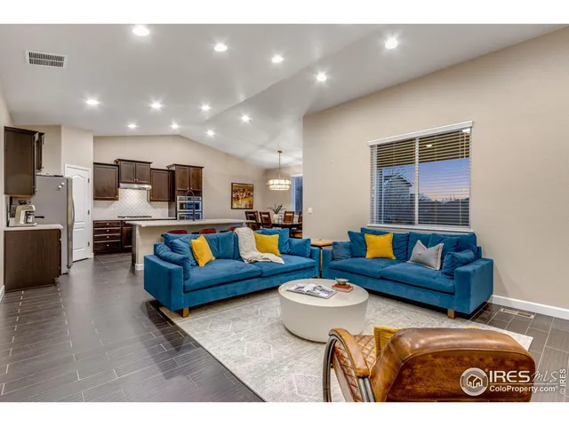 a living room with furniture and kitchen view