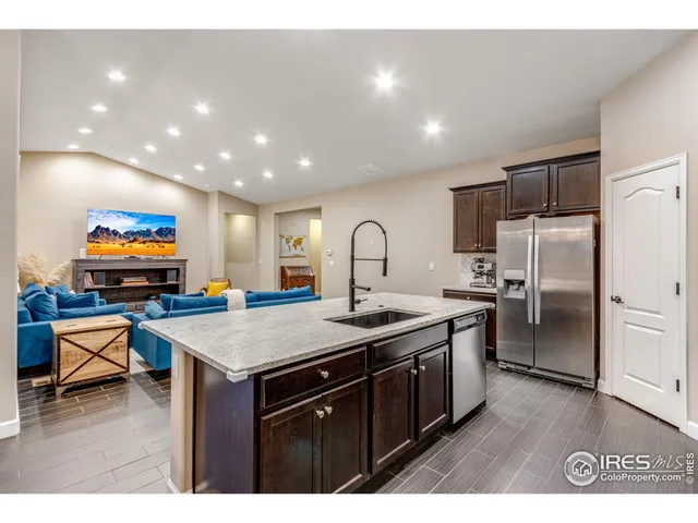 a bathroom with a granite countertop sink a mirror and shower