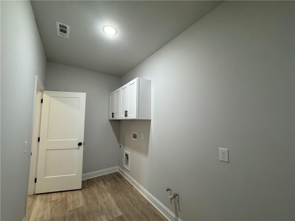 2057 North Hicks Road Toccoa, GA 30577 - Photo 19 of 22 an empty room with wooden floor and windows