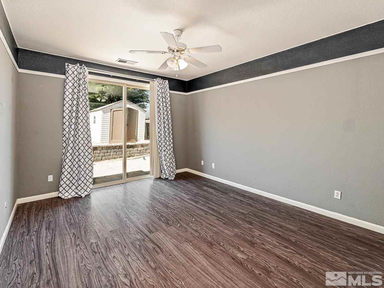 404 Sysonby Court Reno, NV 89521 - Photo 13 of 25 wooden floor in an empty room with a window