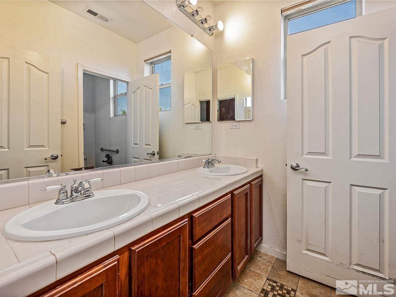 404 Sysonby Court Reno, NV 89521 - Photo 18 of 25 a bathroom with a sink and a mirror