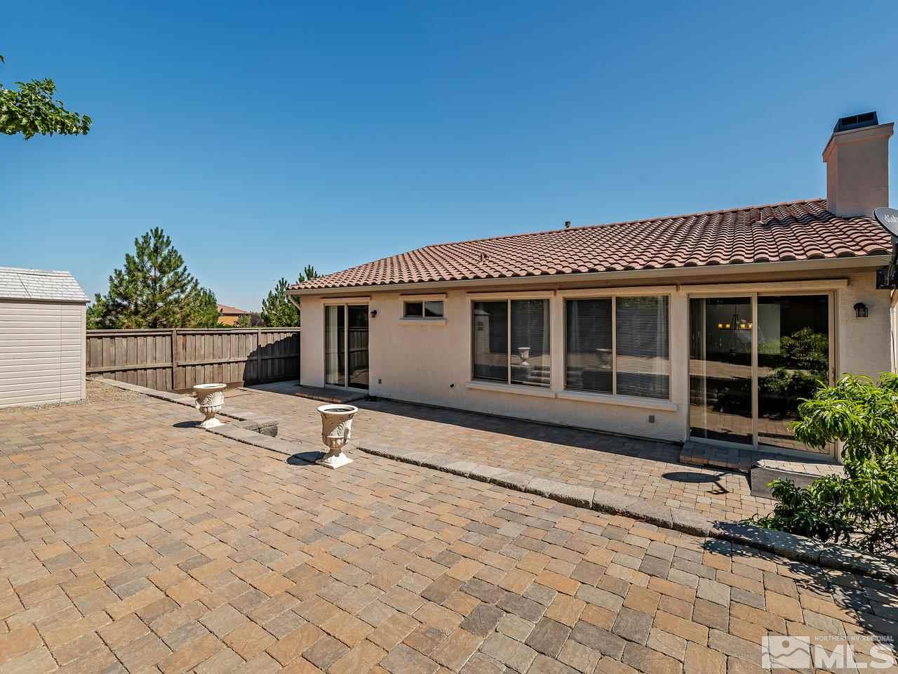 404 Sysonby Court Reno, NV 89521 - Photo 20 of 25 a backyard with a table and chairs and potted plants