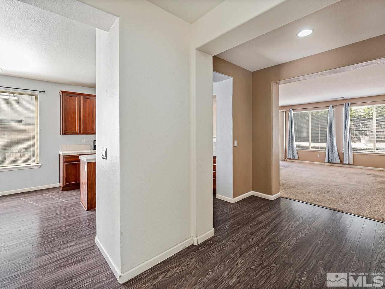 404 Sysonby Court Reno, NV 89521 - Photo 5 of 25 an empty room with wooden floor and windows