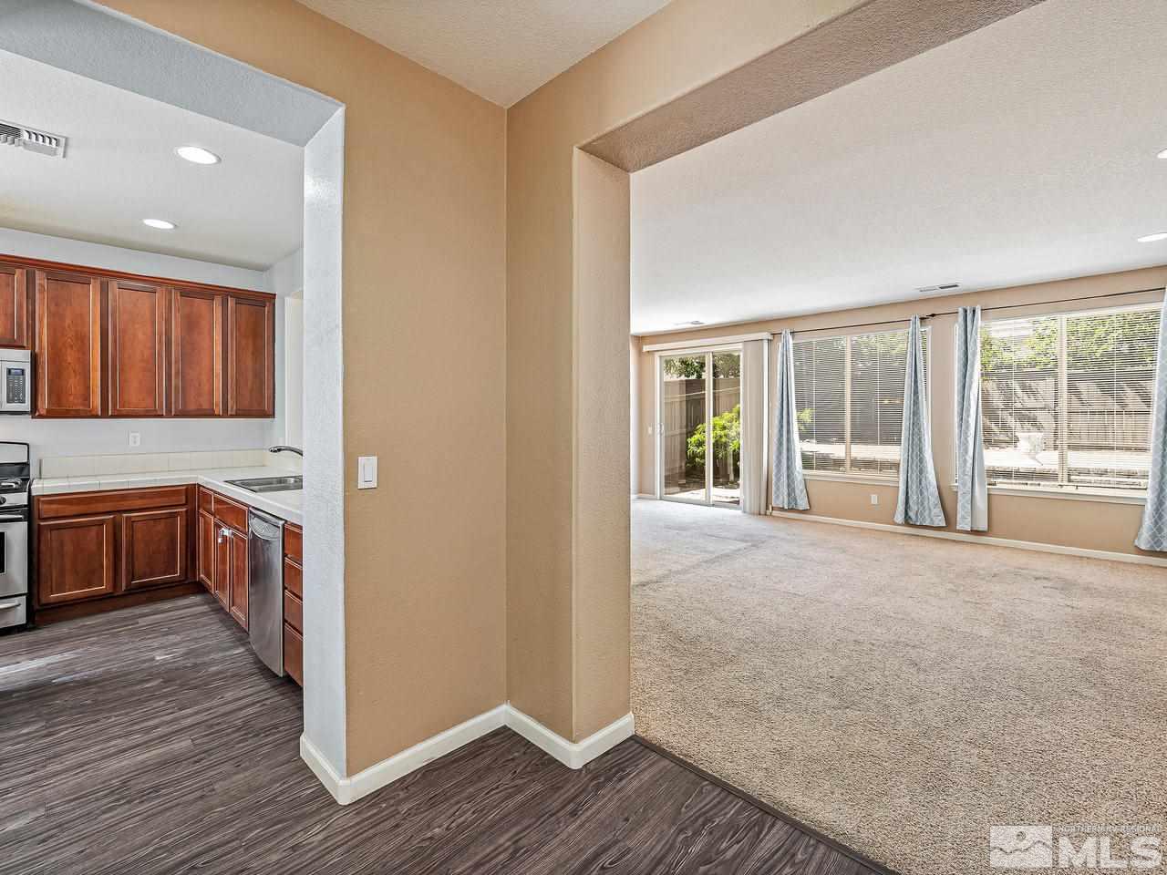 404 Sysonby Court Reno, NV 89521 - Photo 6 of 25 a view of an empty room with wooden floor and a window