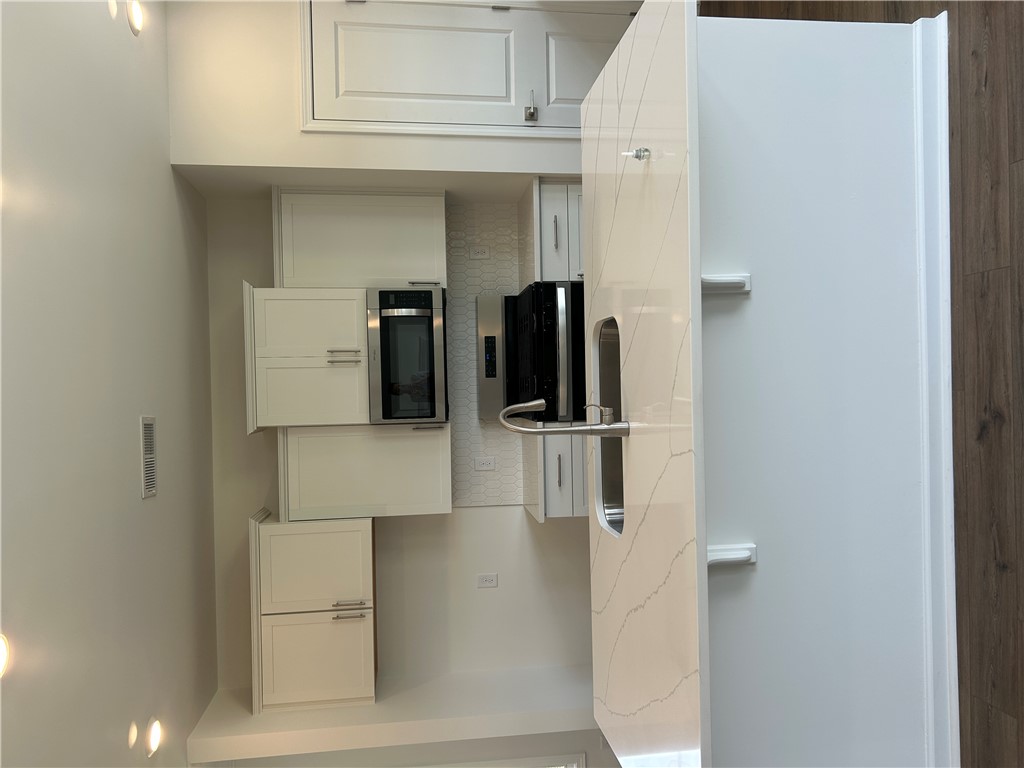 211 Bellflower Lane Anderson, SC 29625 - Photo 10 of 28 Modern kitchen with sleek white cabinetry and built-in appliances offers seamless design.