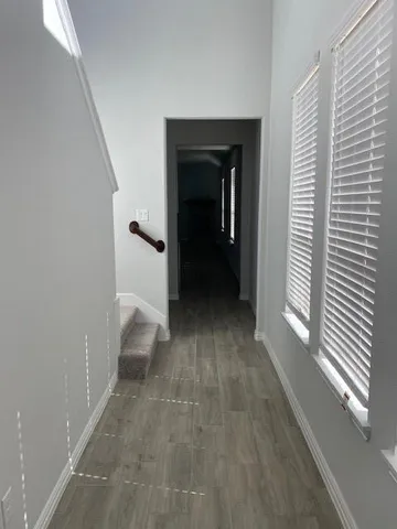 a view of a hallway view with wooden floor and staircase