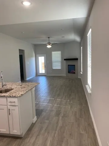 a spacious bathroom with a granite countertop sink a mirror and a vanity