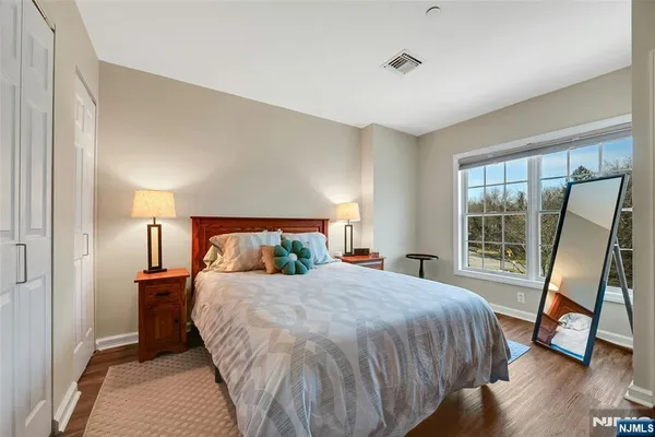 a bedroom with a bed and a large window