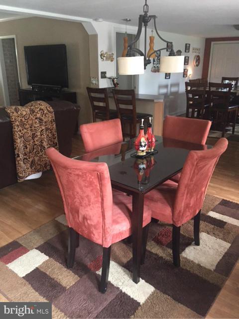 7744 Talbot Run Road Mount Airy, MD 21771 - Photo 10 of 30 a living room with furniture a dining table and a fireplace