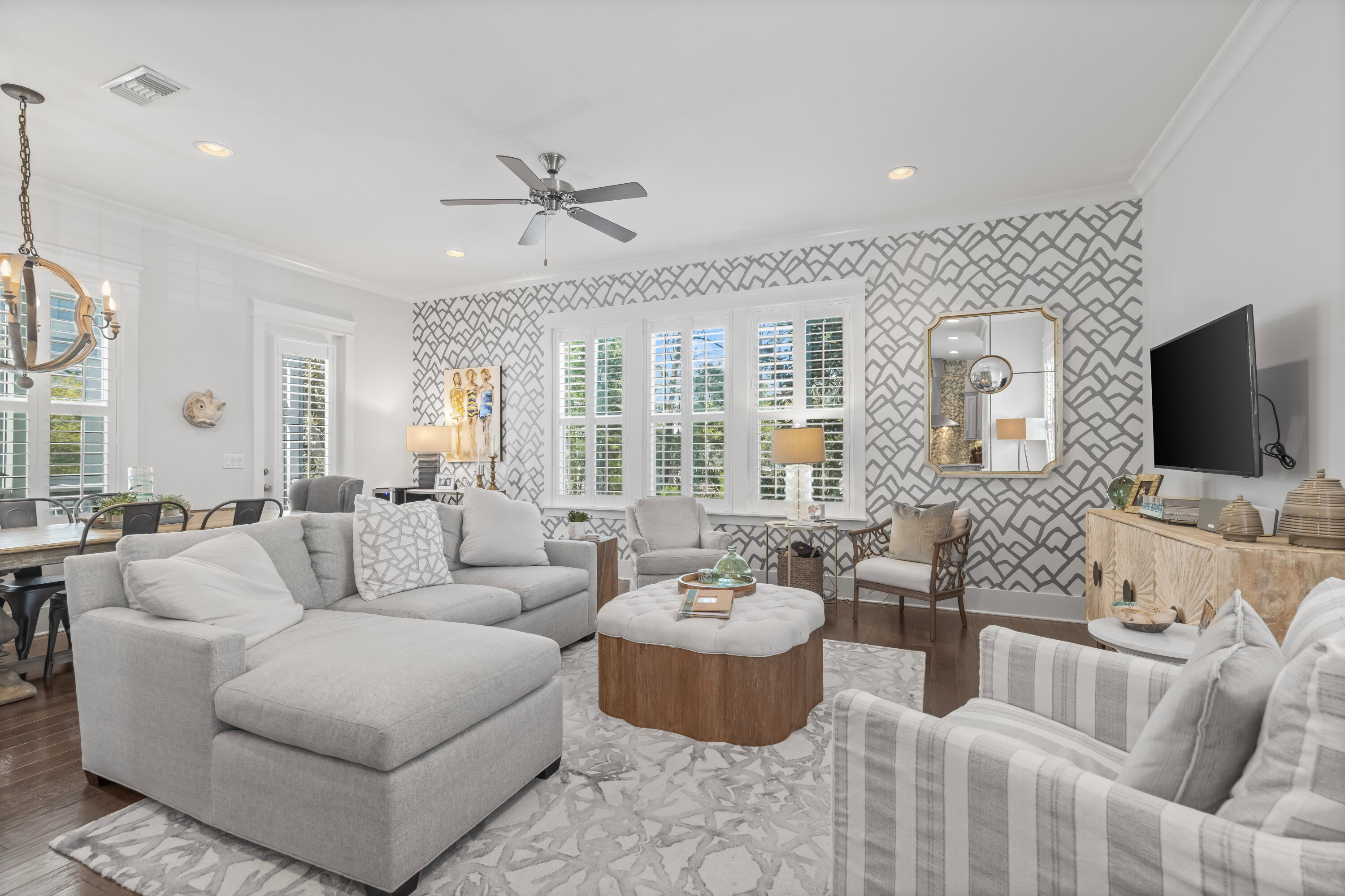 a living room with furniture a flat screen tv and a large window