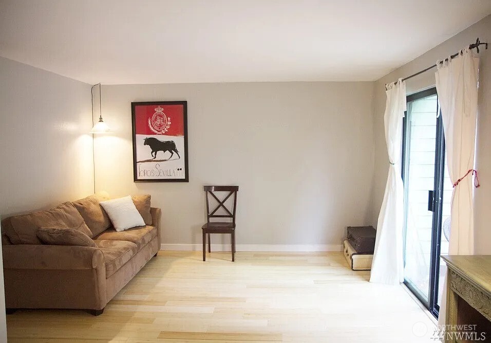 230 Southwest Clark Street, Unit C302 Issaquah, WA 98027 - Photo 3 of 8 a living room with furniture and a flat screen tv