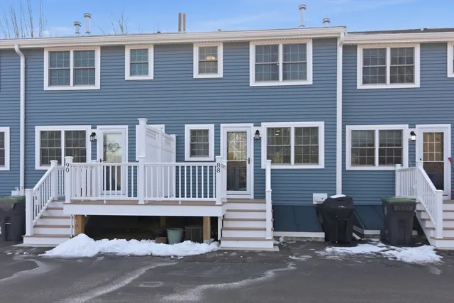 a front view of a house with a parking space