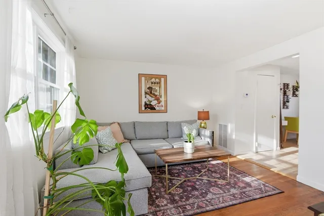 a living room with furniture and a rug