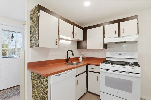 a kitchen with stainless steel appliances granite countertop a sink stove and cabinets
