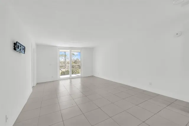 a view of a kitchen with a sink and a refrigerator