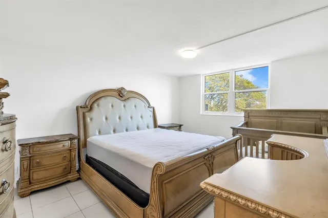 a bedroom with a bed and a dresser