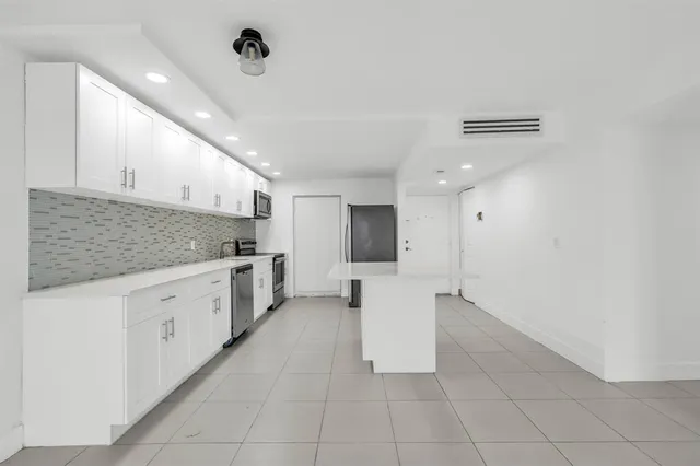 a kitchen with cabinets and white appliances