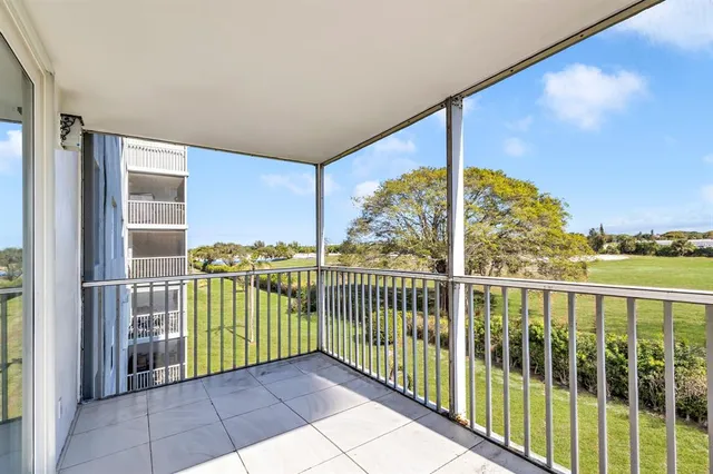 a view of a hallway with wooden floor and entryway