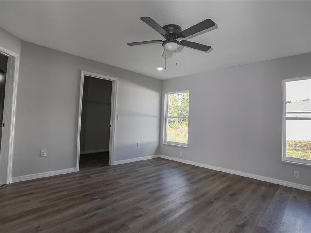 16619 Southwest 31st Circle Ocala, FL 34473 - Photo 11 of 26 a view of an empty room with wooden floor and a window