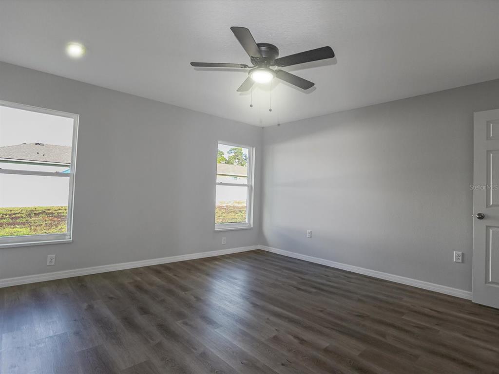 16619 Southwest 31st Circle Ocala, FL 34473 - Photo 12 of 26 a view of an empty room with wooden floor and a window