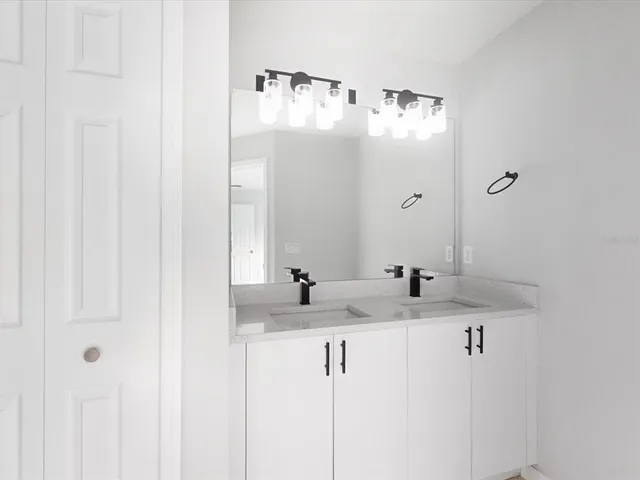 a bathroom with a sink and mirror