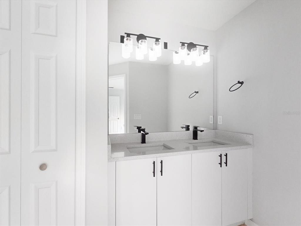 16619 Southwest 31st Circle Ocala, FL 34473 - Photo 13 of 26 a bathroom with a sink and mirror