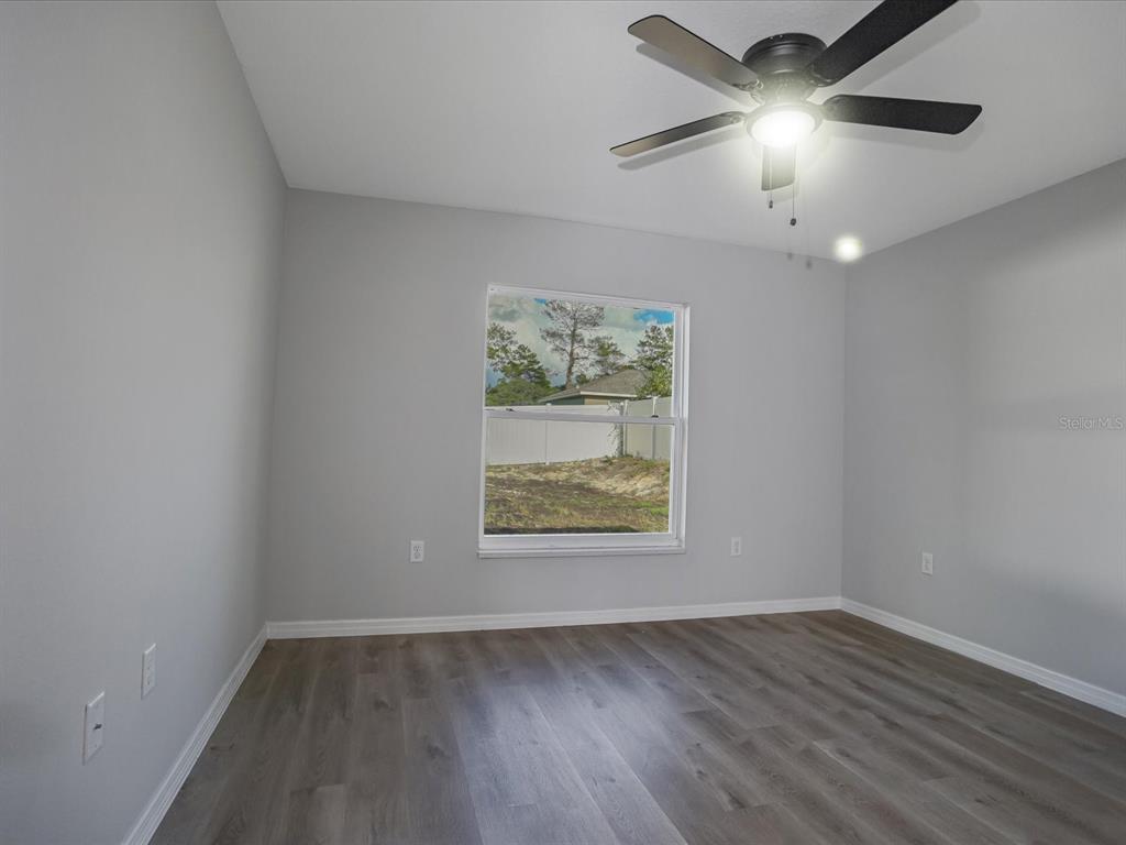 16619 Southwest 31st Circle Ocala, FL 34473 - Photo 15 of 26 wooden floor in an empty room with a window