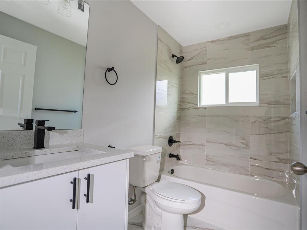 16619 Southwest 31st Circle Ocala, FL 34473 - Photo 17 of 26 a bathroom with a sink a toilet and shower
