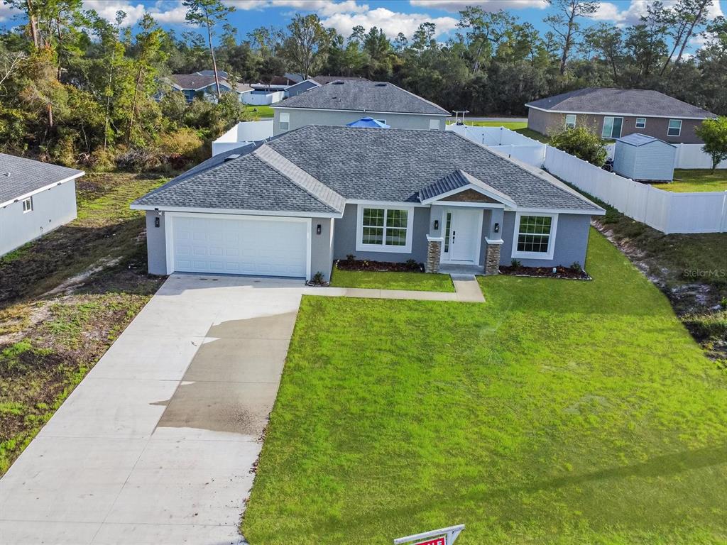 16619 Southwest 31st Circle Ocala, FL 34473 - Photo 2 of 26 an aerial view of house with yard and trees in the background
