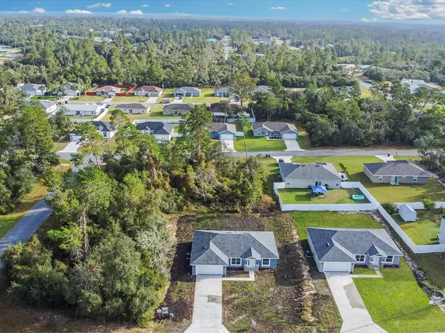 an aerial view of a house with a swimming pool yard and outdoor seating