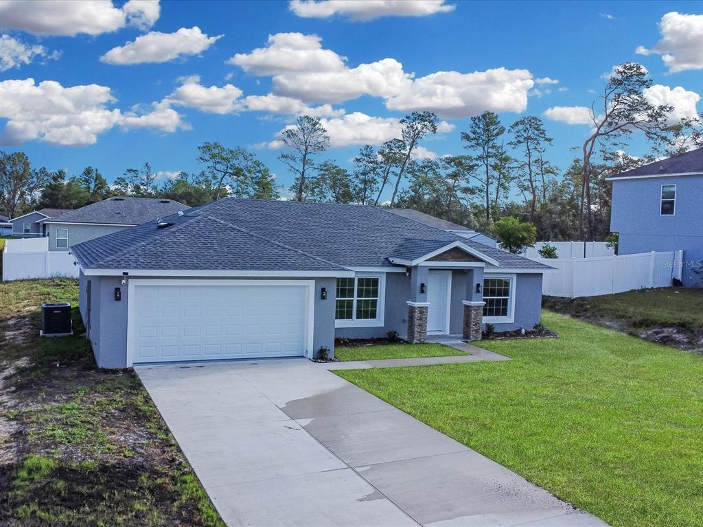 16619 Southwest 31st Circle Ocala, FL 34473 - Photo 3 of 26 a front view of a house with garden