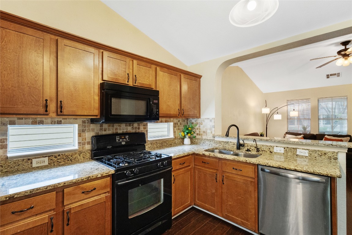 317 Strawn Kyle, TX 78640 - Photo 12 of 38 a kitchen with a sink stove and microwave