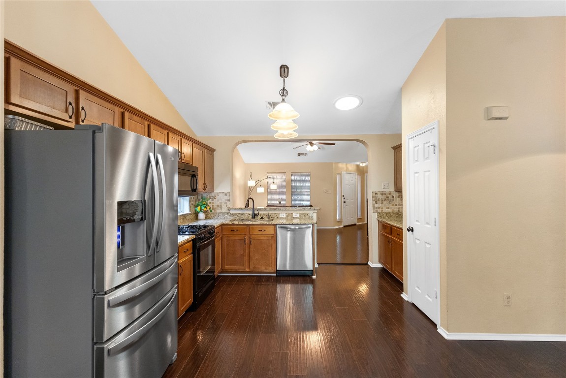 317 Strawn Kyle, TX 78640 - Photo 15 of 38 a kitchen with refrigerator a stove and wooden floor