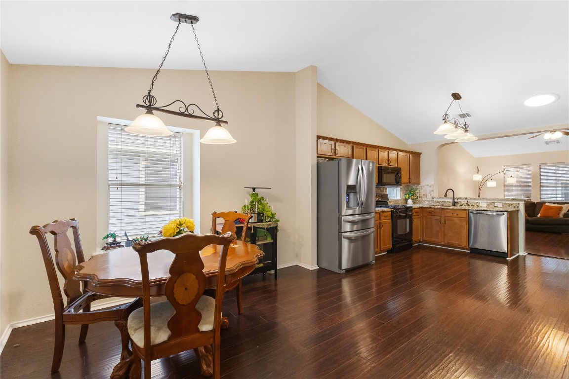 317 Strawn Kyle, TX 78640 - Photo 16 of 38 a view of a dining room and livingroom with furniture wooden floor a chandelier