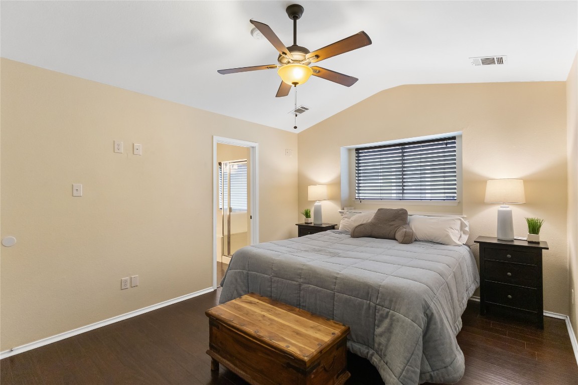 317 Strawn Kyle, TX 78640 - Photo 20 of 38 a bedroom with a bed and a chandelier