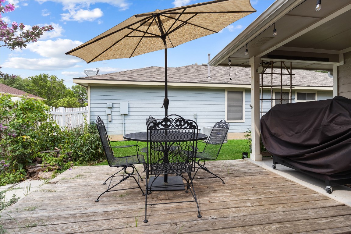 317 Strawn Kyle, TX 78640 - Photo 30 of 38 a patio with a table and chairs under an umbrella