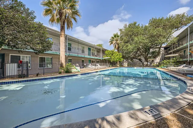 a view of a swimming pool with a table and chairs