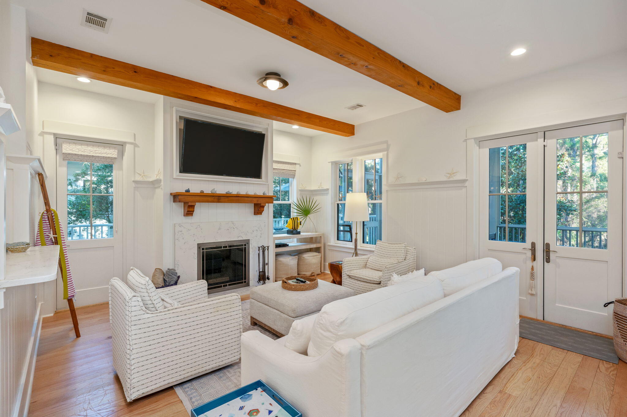 60 Red Cedar Way Santa Rosa Beach, FL 32459 - Photo 18 of 75 a living room with furniture a flat screen tv and a fireplace