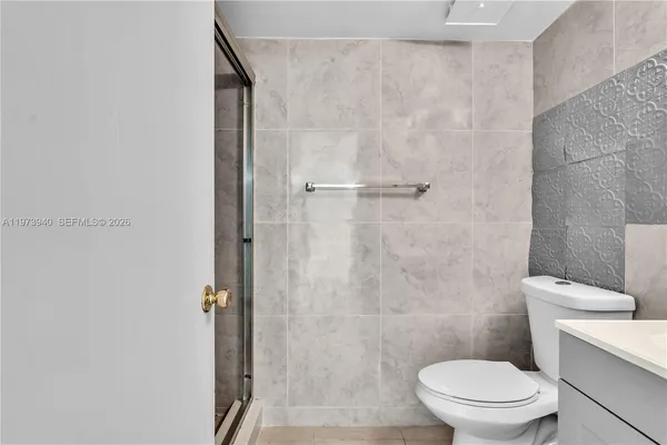 a bathroom with a sink mirror and toilet