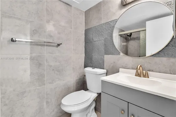 an empty room with chandelier fan