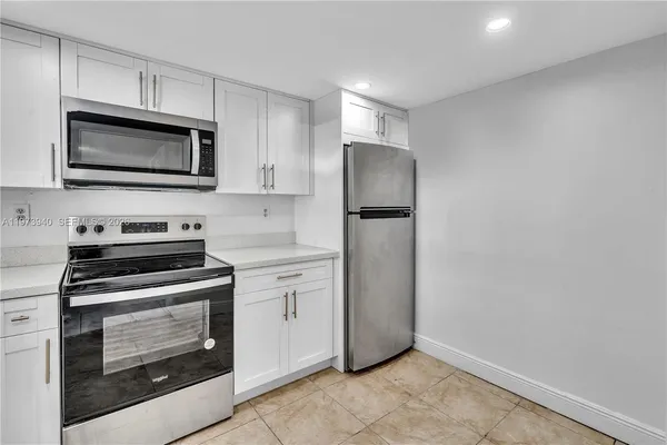 a kitchen with a stove microwave and refrigerator