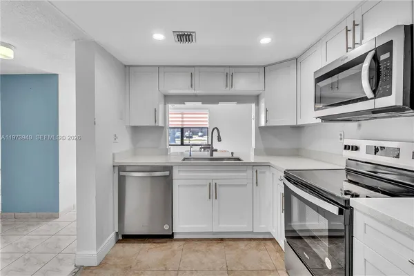 a kitchen with a sink stove and microwave